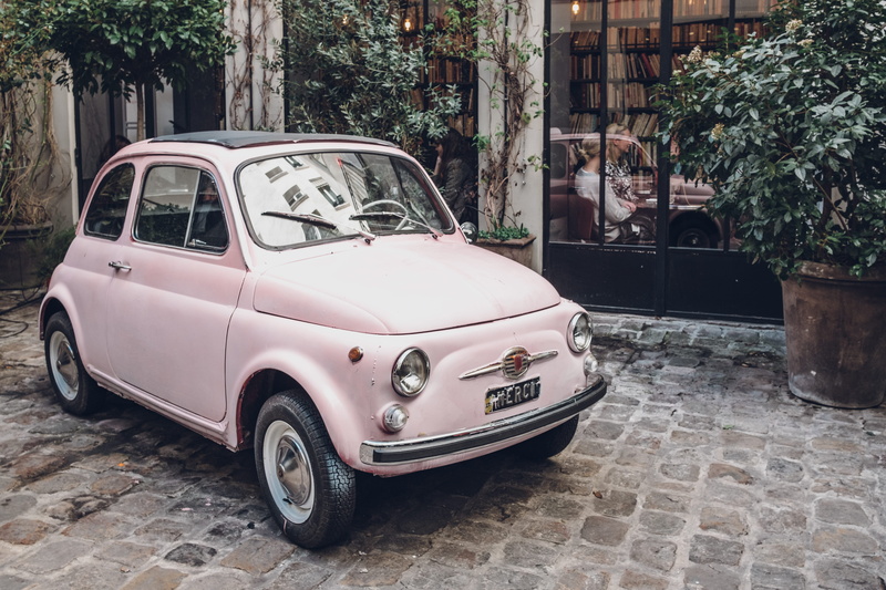 vintage car, car, day, built structure, nature, street, retro styled, land vehicle, floor, mode of transportation, window, plant, paving stone, building exterior