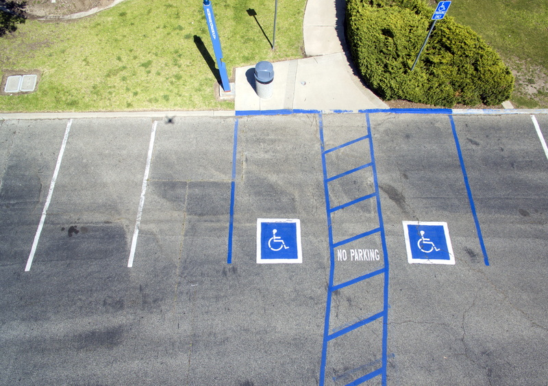 daytime, footpath, grass, guidance, transportation, no people, road, high angle view, parking lot, outdoors, symbol, disabled sign, city, sign, marking