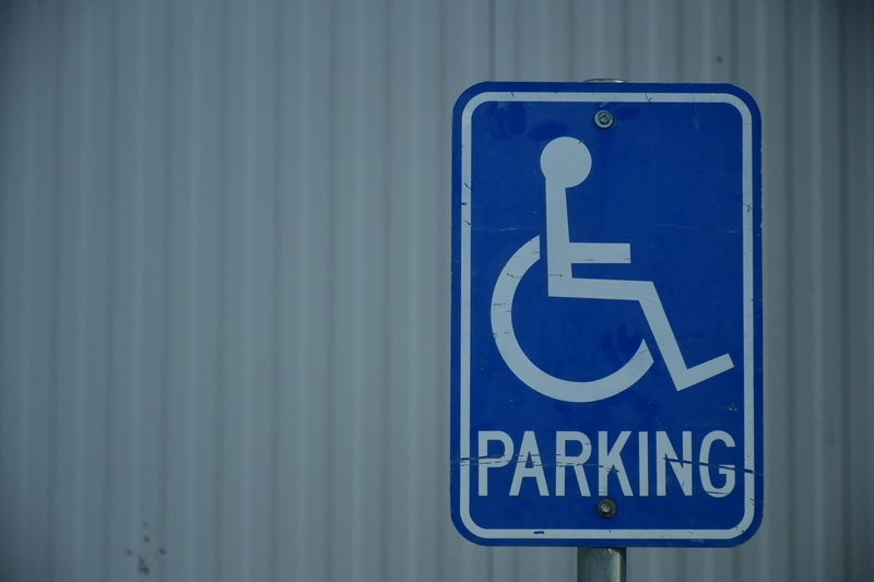 information sign, disabled sign, land vehicle, differing abilities, representation, transportation, roller coaster, emblem, western script, oilfield, symbol