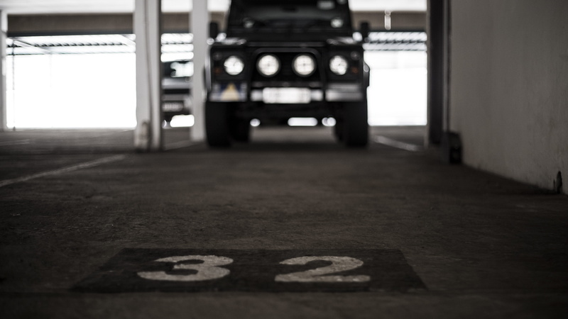 light, lighting, mode of transportation, city, parking lot, headlight, transportation, sports car, sign, numbered, tarmac, selective, focus, race car, floor