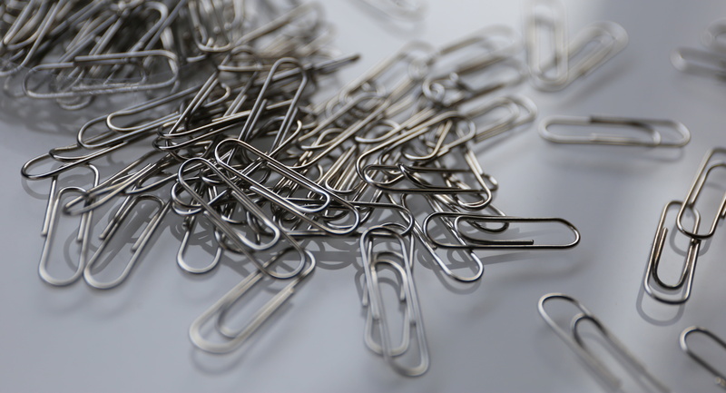 clip, table, problem, large group of objects, high angle view, indoors, metal, white background, choice, silver colored, no people, trouble, confusion
