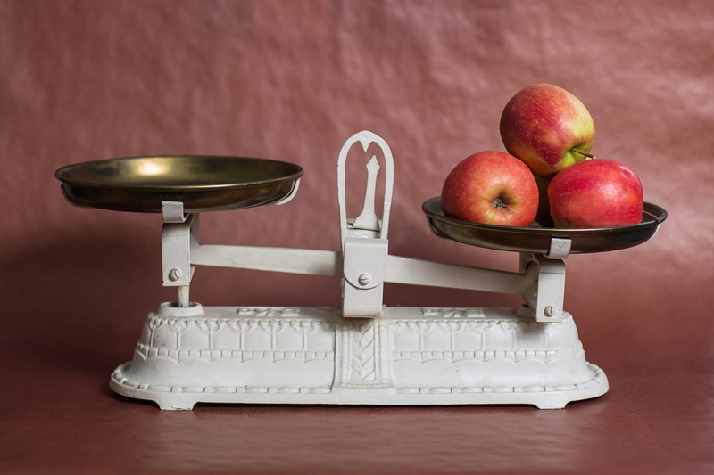 small group of objects, nutrition, metal, steel, still life, indoors, white, scale, no people, balancing, weight scale, group of objects, apple - fruit