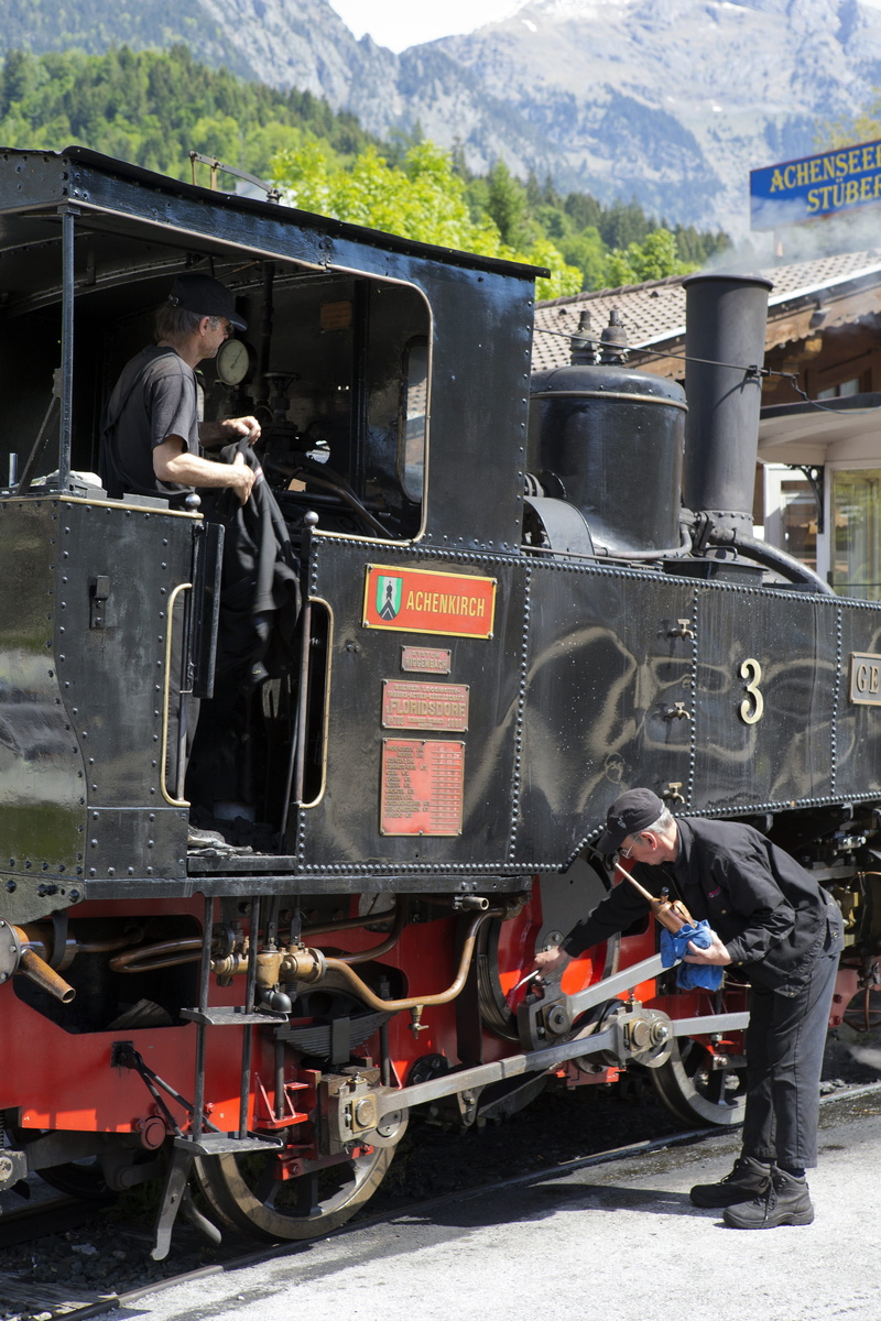 outdoors, people, train - vehicle, locomotive maintenance, real people, transportation, austria, passenger train, engine smoke, men, occupation, mode of transportation