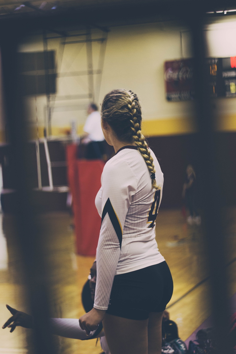 three quarter length, women, volleyball, sideway, blonde, woman, hairstyle, plait, facing, focus, clothing, inside, exercise, shallow, side view, standing