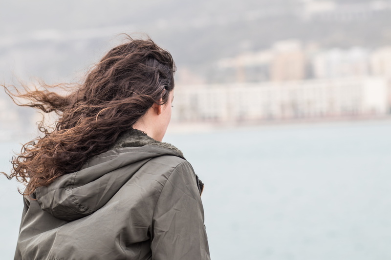 brown hair, hair, standing, adult, spontaneous, hood - clothing, focus on foreground, wind, water, leisure activity, italy, women, real people, province of salerno