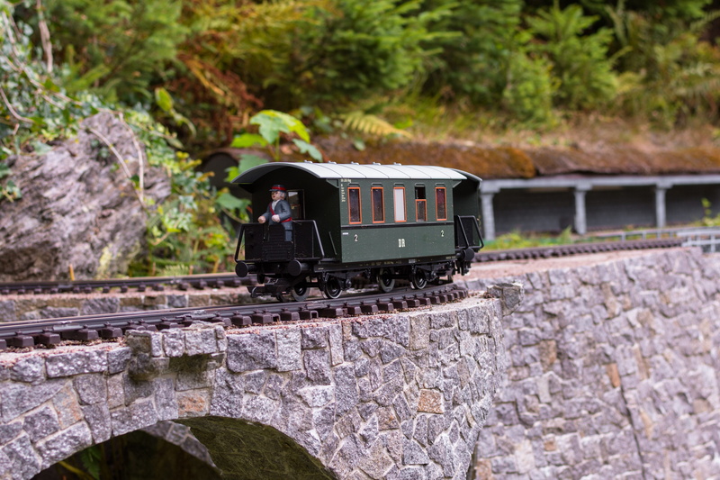 window, train, wheels, old, no people, outdoors, nature, track, transportation, mode of transportation, rock - object, plant, wagon, traffic, rock, stone wall