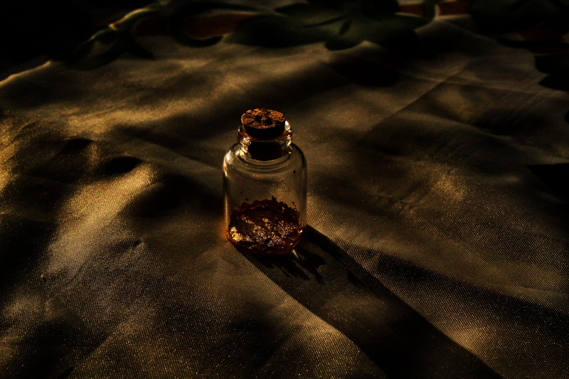 high angle view, decoration, perfume sprayer, table, vial of gold, no people, food and drink, spice, indoors, still life, night, pepper - seasoning, close-up