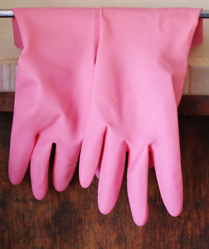 indoors, lifestyles, real people, finger, gloves, females, putz utensils, human leg, low section, pink color, rubber gloves, one person, adult, human foot