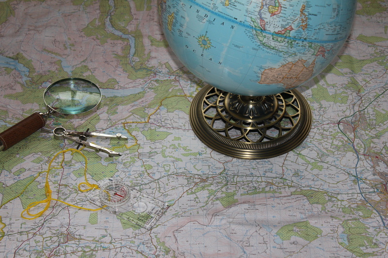 hiking, group of objects, close-up, glass, indoors, adventure, exploration, floral pattern, technology, reading, compass, leisure, map, still life, pattern