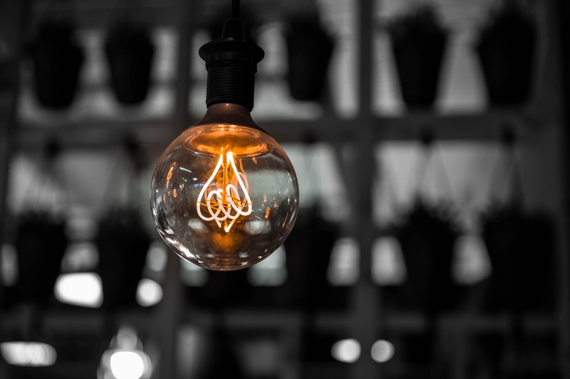 single object, electric light, selective focus, rustic, fuel and power generation, edison, light bulb, filament, dark, focus on foreground, photography