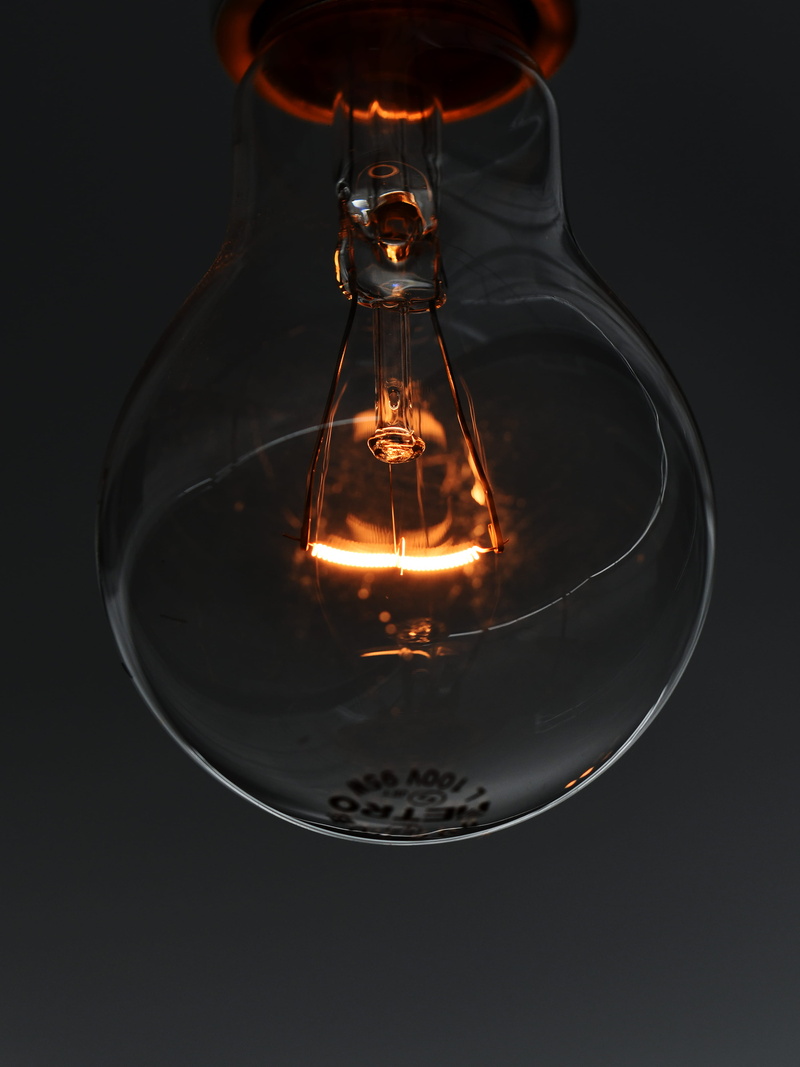 aoyama, incandescent, interior, studio shot, dark, macro, glass, black, black background, goblet, glowing, curve, electric light, bulb, closeup, 4K, lightbulb