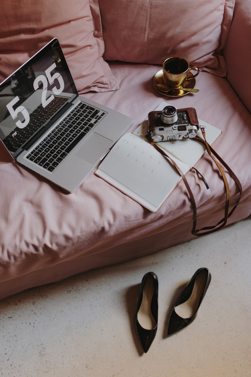 publication, indoors, paper, no people, pink, home office, book, sofa, female office, study, table, room, macbook, female, bed, laptop, portable information device