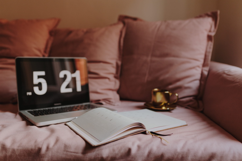 pen, glass, laptop, room, book, home office, pink, couch, focus on foreground, table, furniture, macbook pro, absence, sofa, study, domestic room, living room