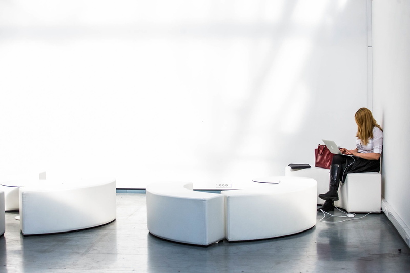 full length, communication, women, using, wireless technology, alone, building, young adult, couch, adult, ottoman, laptop, side view, business person