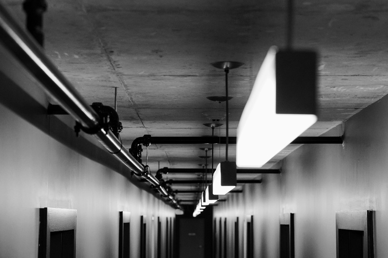concrete, light, electricity, hanging, illuminated, wall - building feature, building, direction, low angle view, night, doors, lighting equipment, architectural column
