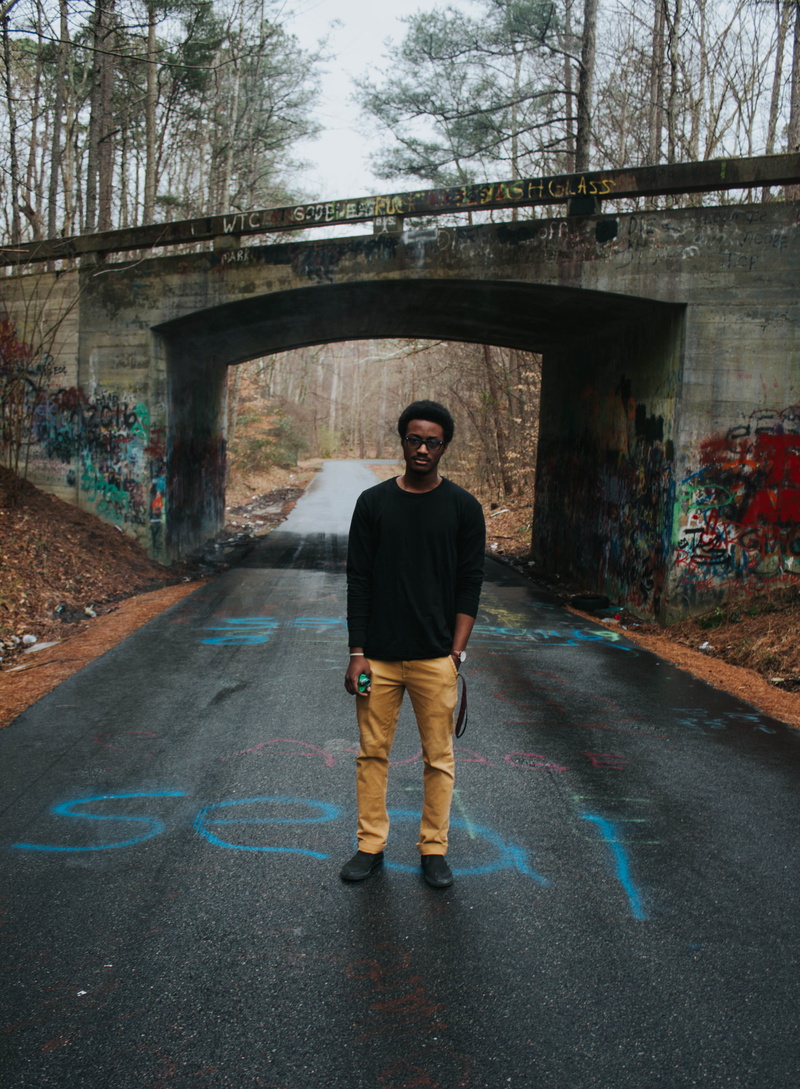 sunglasses, adult, graffiti, trees, day, real people, daylight, photoshoot, casual clothing, recreation, built structure, 4K, tunnel, full length, one person