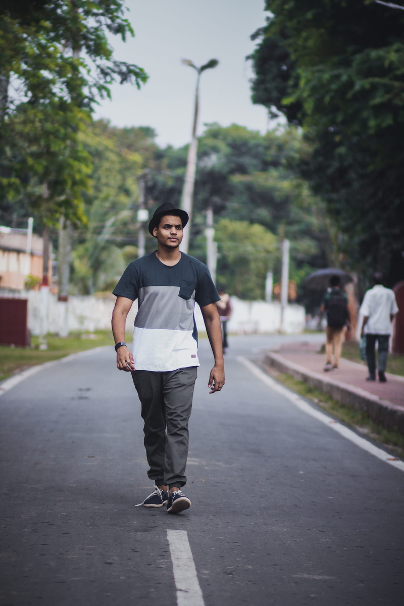 apparel, plant, sneaker, leisure activity, walking, shorts, middle, pants, focus on foreground, tarmac, 5K, street, casual clothing, sports, looking at camera