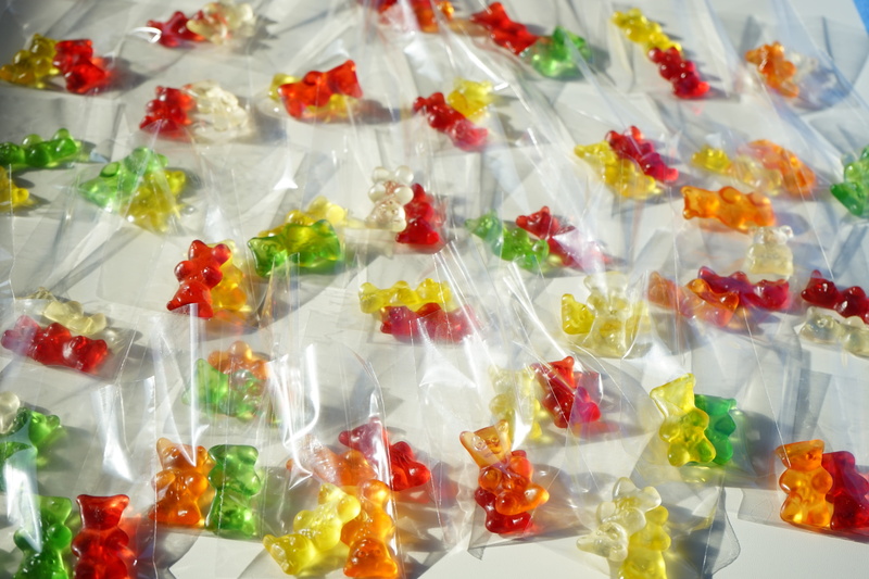 in a row, sweet, bear, glass, color, plastic, sweetness, delicious, fruit jelly, cold temperature, gummi bears, temptation, indoors, retail, sachets, gold bears