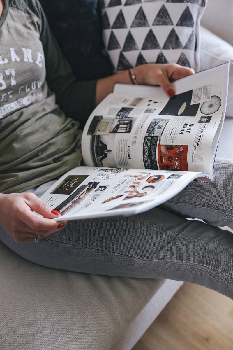 magazine, sitting, business, adults only, real people, reading, adult, paper Currency, technology, indoors, table, women, Woman reading, style, holding