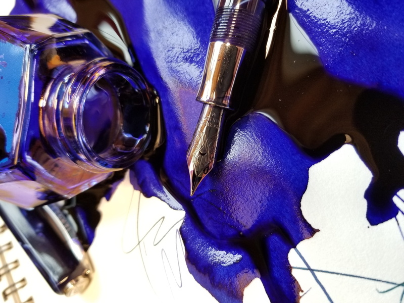 indoors, day, blue, inkwell, fountain, spoiled, directly above, spilled, black, musical equipment, pen, art and craft, still life, creativity, pooled, focus on foreground