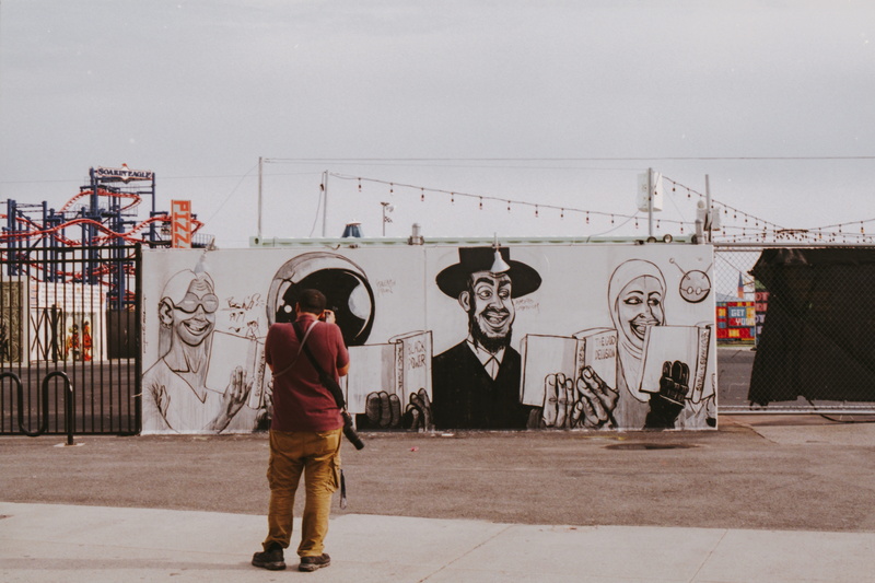 daytime, representation, outdoors, real people, fitness, built structure, lifestyles, clothing, mural, text, sports, architecture, city, modern art, human representation