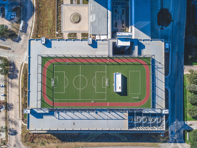 built structure, architecture, outdoors, 4K, text, field, building, train - vehicle, rail transportation, pitch, train, transportation, city, aerial, court