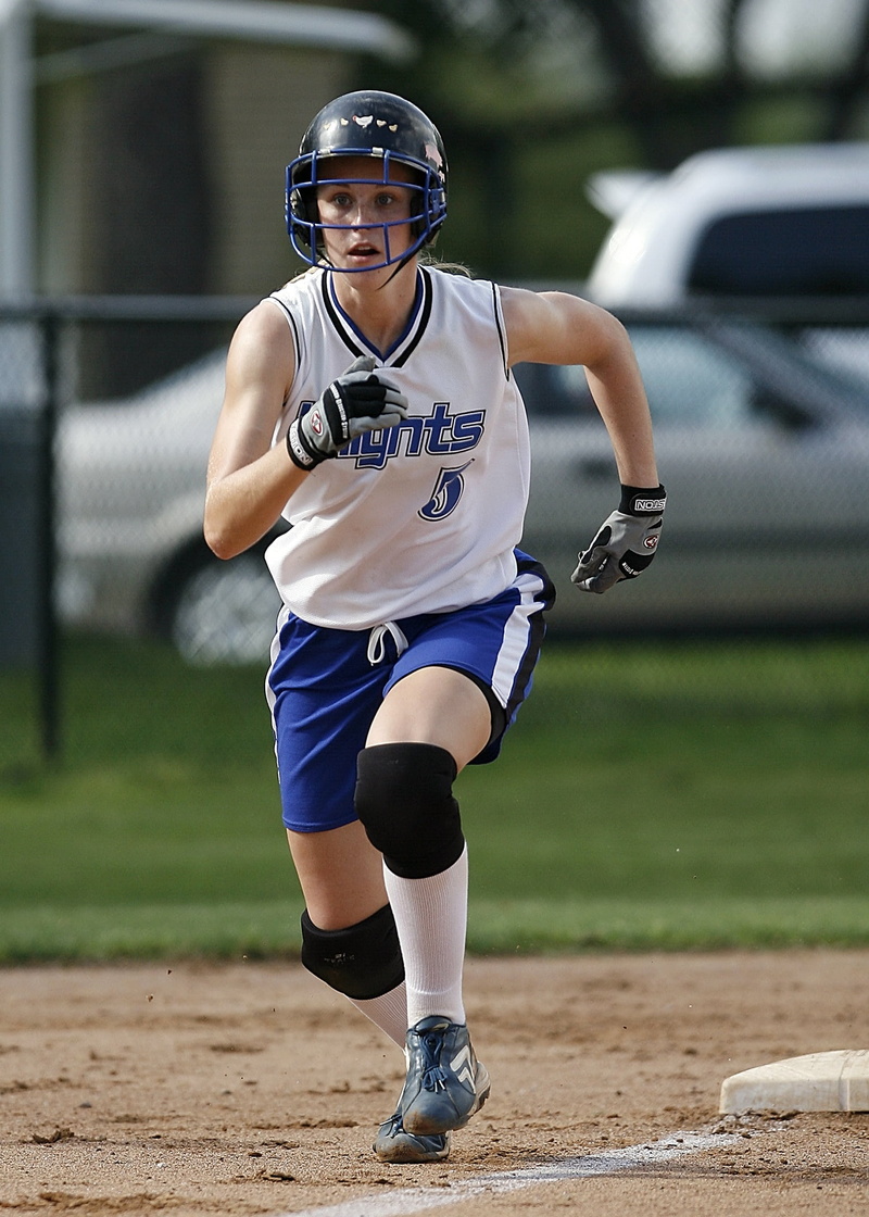 front view, player, leisure activity, concentration, uniform, runner, real people, girl, teen, young, intent, scoring, third base line, helmet, clothing
