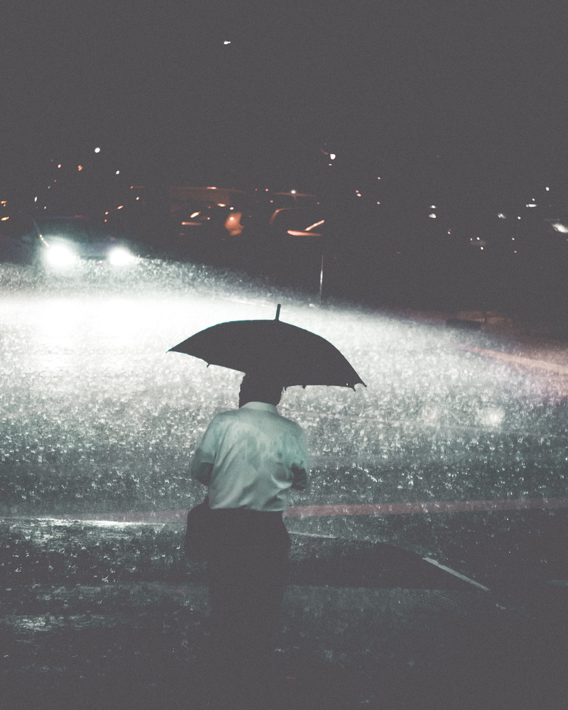 road, standing, timeless, lens flare, illuminated, night, real people, monsoon, rear view, lifestyles, city, protection, security, moment, streetphotography
