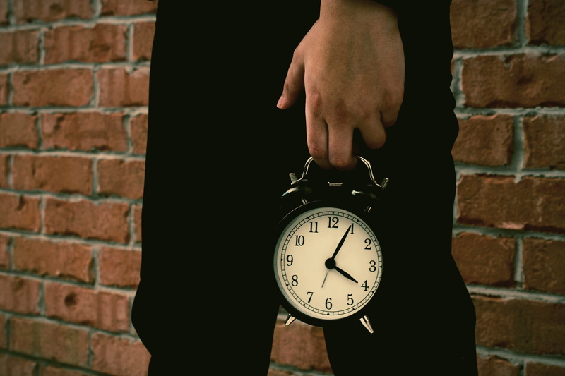 human hand, body part, human body part, minute hand, number, alarm clock, day, holding, brick, real people, finger, timeless, close-up, boy, clock face