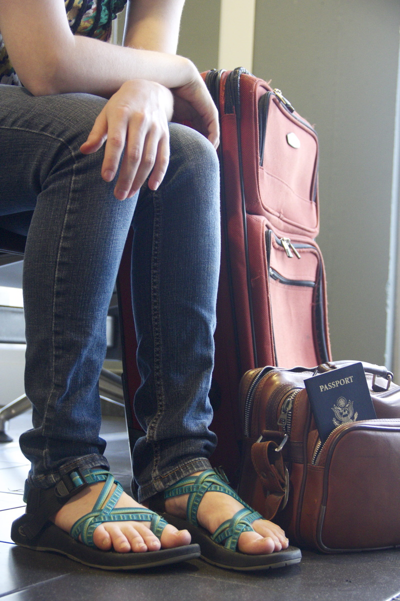 jeans, casual clothing, person, indoors, body part, luggage, beside, human leg, flat shoe, lifestyles, people, low section, traveler, journey, real people