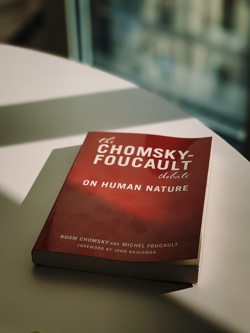 close-up, sign, indoors, text, day, book, chomsky, selective focus, still life, shadow, western script, 2K, no people, message, foucault, publication