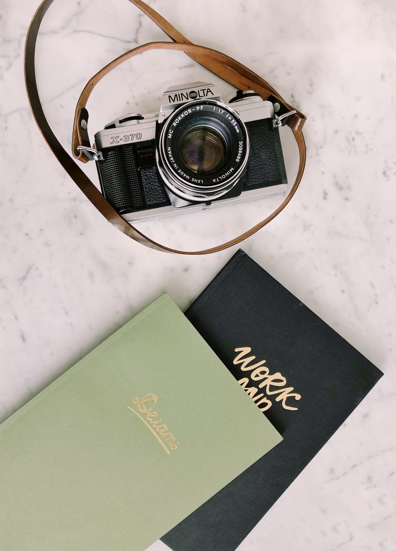 text, high angle view, non-western script, lens - optical instrument, no people, indoors, photographic equipment, camera - photographic equipment, activity