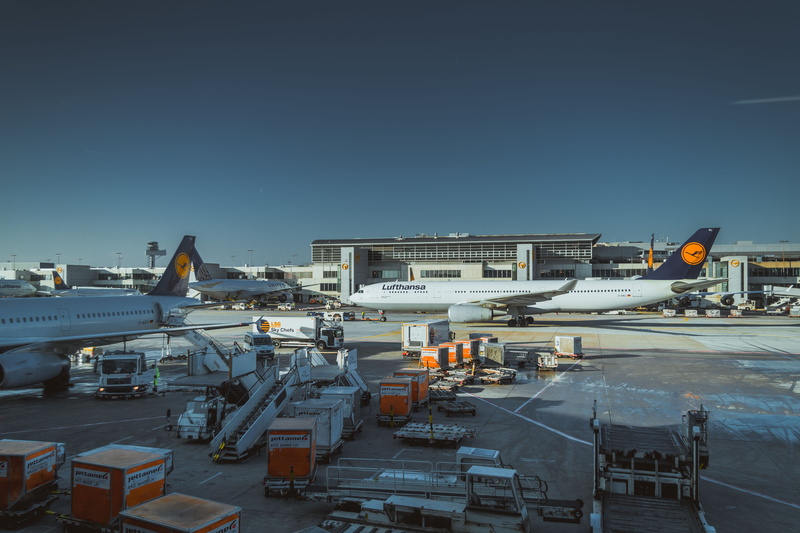 air vehicle, van, transportation, architecture, airport runway, 5K, container, built structure, road, trip, airline, incidental people, buildings, outdoors