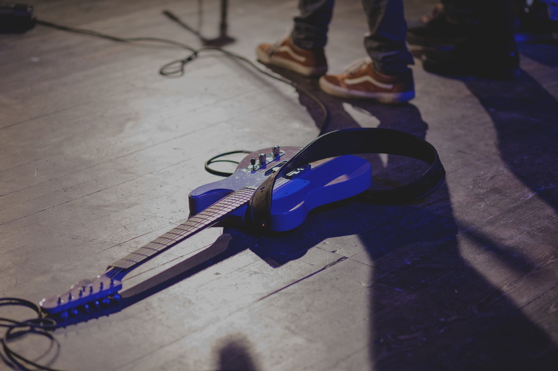 performance, human body part, real people, lifestyles, show, shadow, outdoors, one person, incidental people, player, street, human leg, music, musician