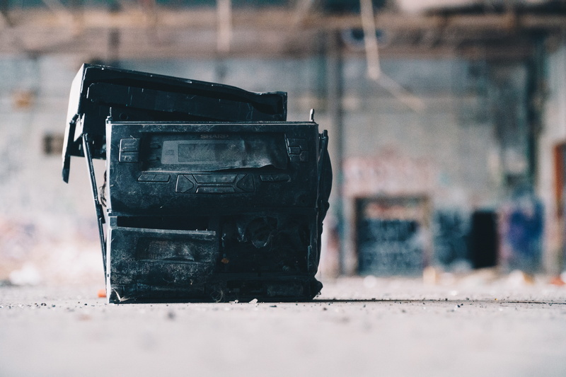 abandoned, technology, built structure, sticker, tire, city, outdoors, alloy wheel, label, black, adapter, obsolete, run-down, armory, metal, machine, deterioration