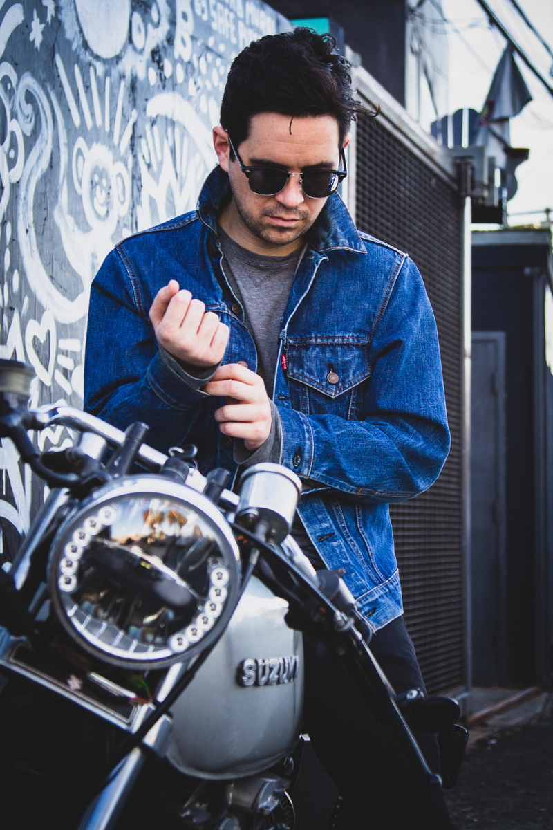 accessories, musical instrument, biker, accessory, person, one person, motorcycle, leisure activity, day, sunglasses, finger, sitting, vehicle, mid adult men