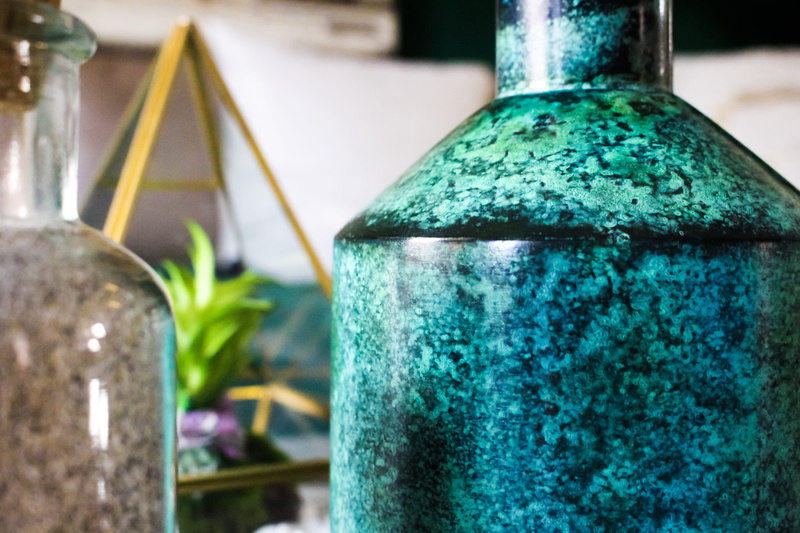 bottle, focus on foreground, household equipment, alcohol, gold, yellow, interior, darkgreen, style, decor, turquoise colored, dark, beverage, design, pillow