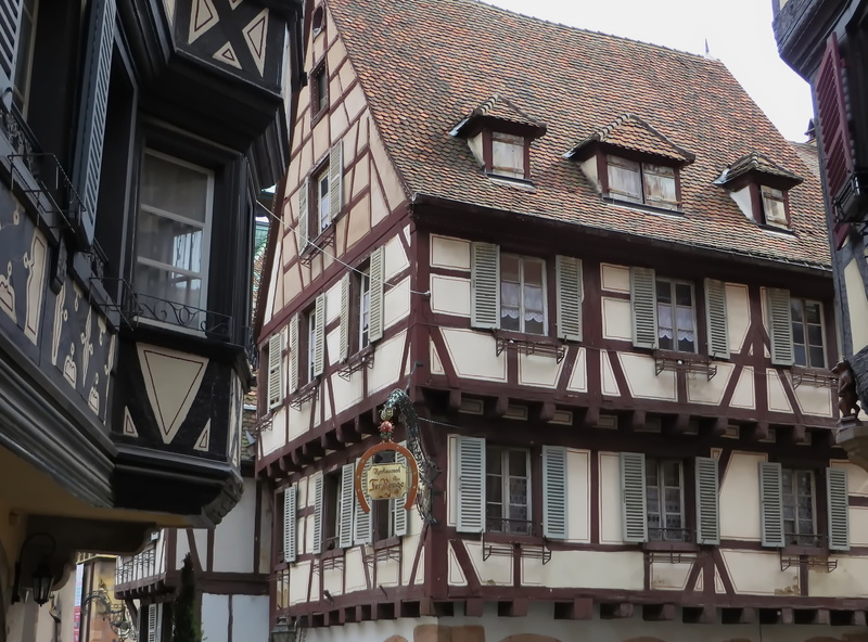 window, low angle view, apartment, 2K, city, colmar, old houses, row house, ornate, sky, facades, pinions, no people, residential district, roof, town