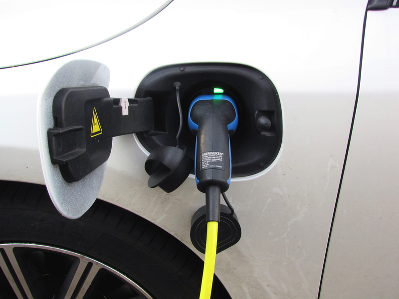 close-up, outdoors, renewable energy, focus on foreground, refueling, car, parked, power cable, control, filling, mode of transportation, motor vehicle