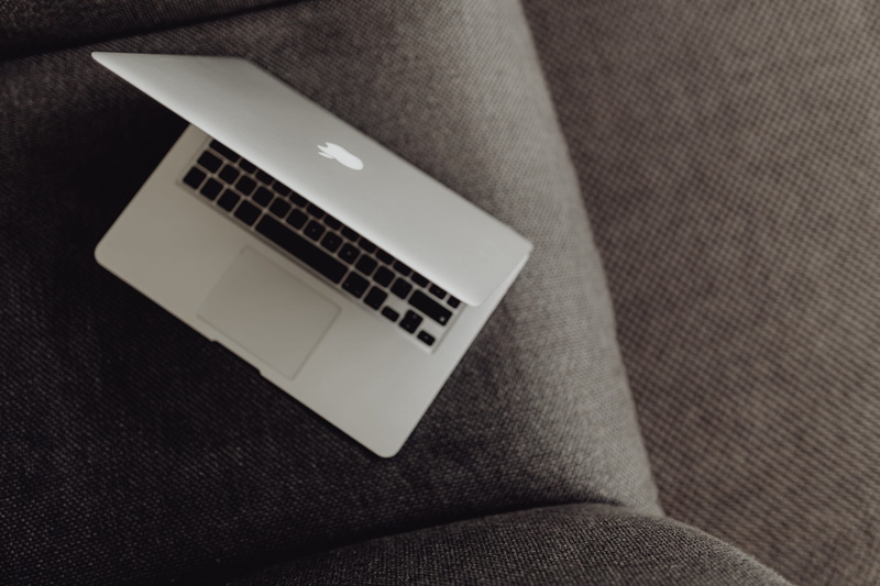 close-up, laptop, arts culture and entertainment, lying, one person, armchair, macbook, view, still life, textile, furniture, computer, grey, communication