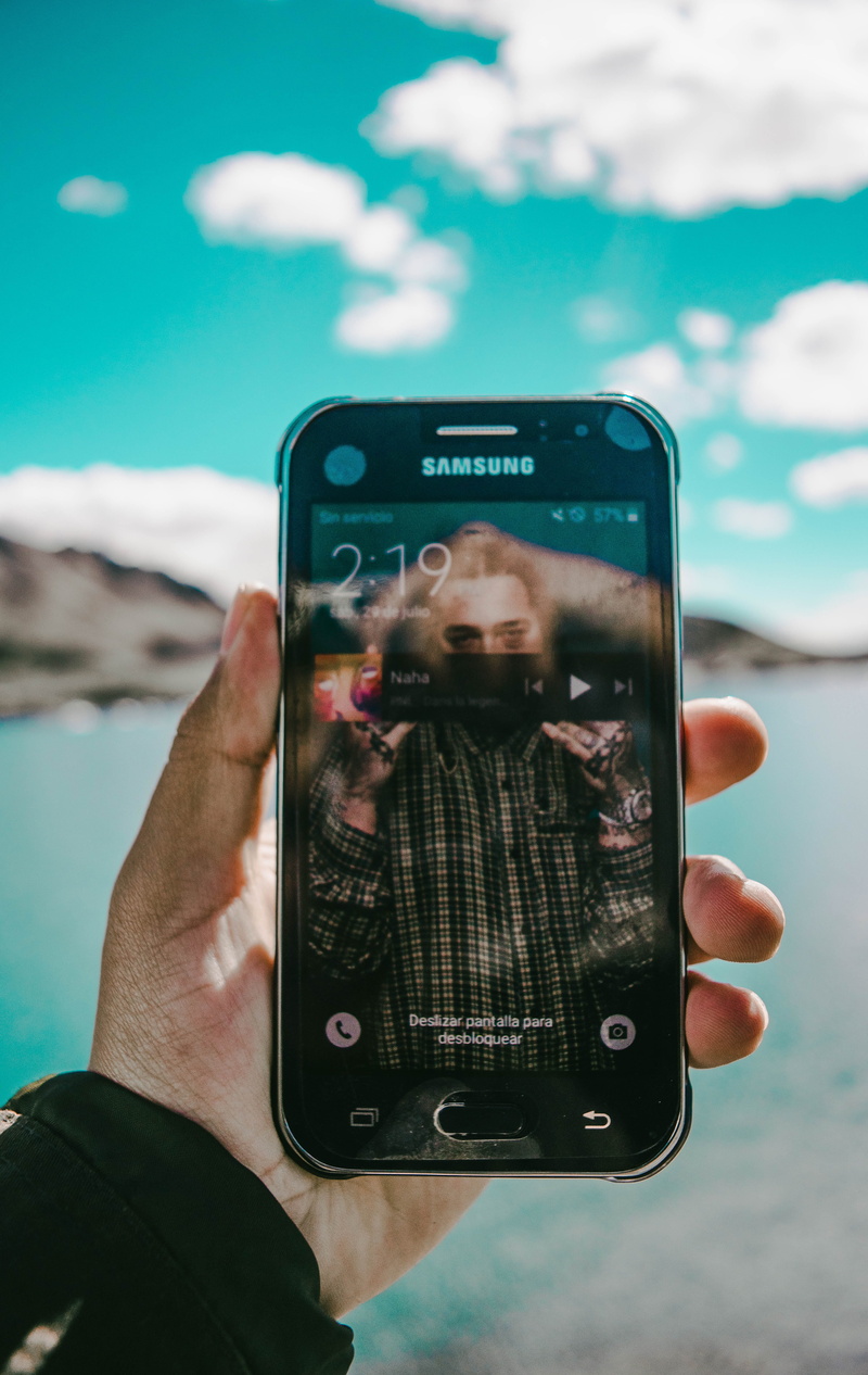 real people, lake, smart phone, one person, white, sea, view, photography themes, phone, wireless technology, water, photo, communication, sky, portable information device