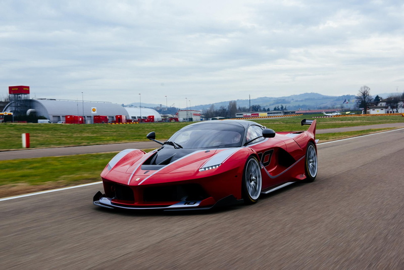 road, land vehicle, motion, transportation, sports race, red, sky, auto racing, architecture, racecar, car, supercar, track and field, motor racing track