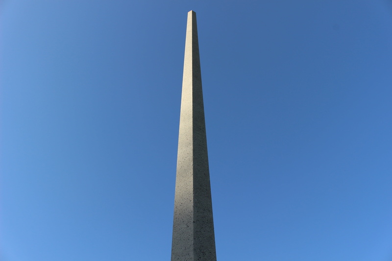 architectural column, city, art, architecture, sunlight, sport, sky, tall - high, climb, no people, built structure, outdoors, pillar, metal, penetrate