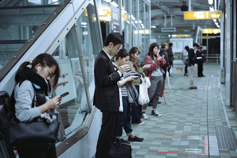 architecture, flooring, digital age, group of people, tech, train, tile, smartphones, isolated, indoor, texting, person, gray, railroad station, technology