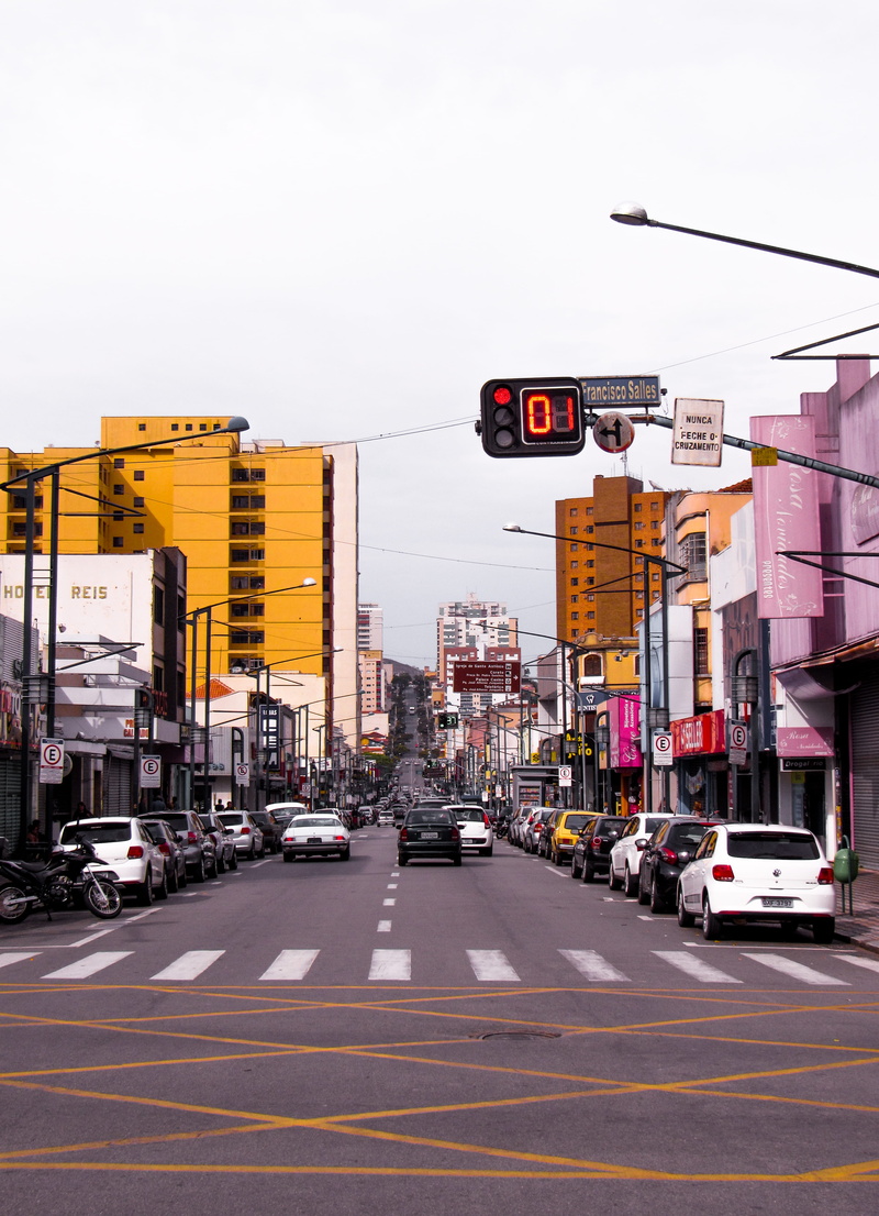 daytime, city, sign, mode of transportation, city street, motor vehicle, text, communication, light, building exterior, suring, sky, road sign, land vehicle