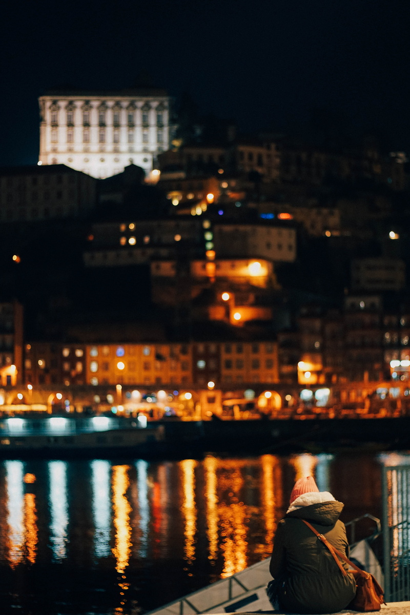 cap, body, black, orange, rear view, parka, cityscape, lighted, nature, lifestyles, built structure, jacket, mirrored, river, sky, city life, building exterior