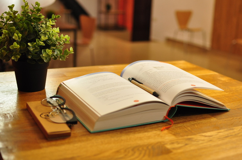 open, no people, book, textbook, study, wooden, learning, close-up, indoors, note pad, library, paper, wood - material, knowledge, nature, eyeglasses, selective focus