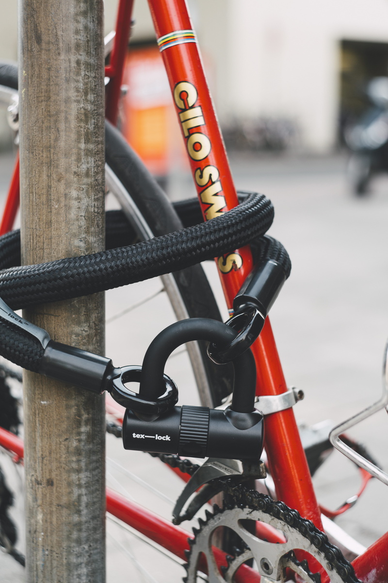 connection, road bike, day, tex lock, transportation, black, focus on foreground, bike, railing, red, land vehicle, close-up, orange, orange color, no people