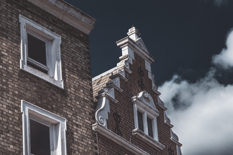 outdoors, built structure, window, place of worship, roof, the past, snow, day, no people, brick, winter, belief, silhouette, steeple, low angle view, sky