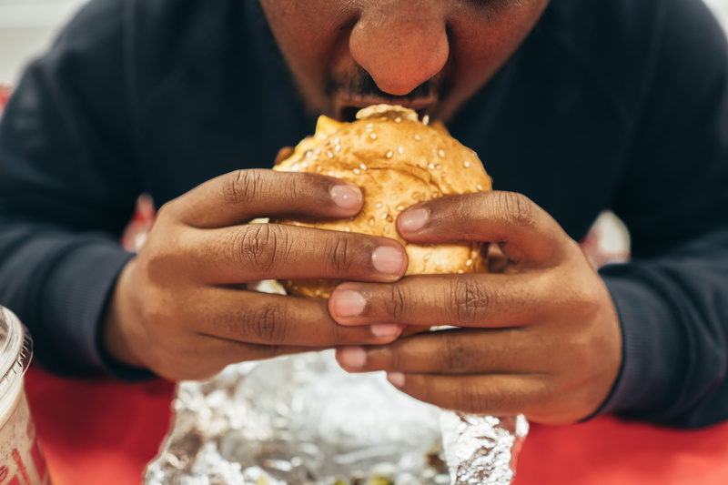 man, burger, human hand, snack, males, one person, temptation, casual clothing, unhealthy eating, indoors, meal, close-up, holding, fast food, hand, food and drink